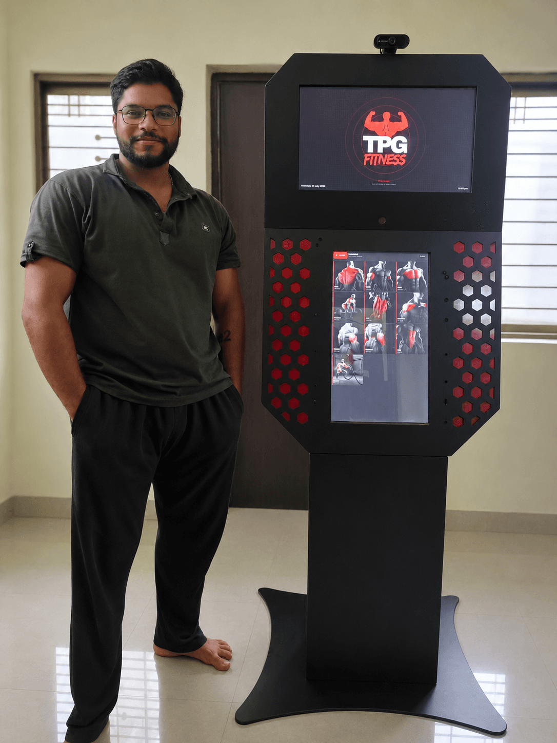A TPG Fitness team member standing beside a finished kiosk unit