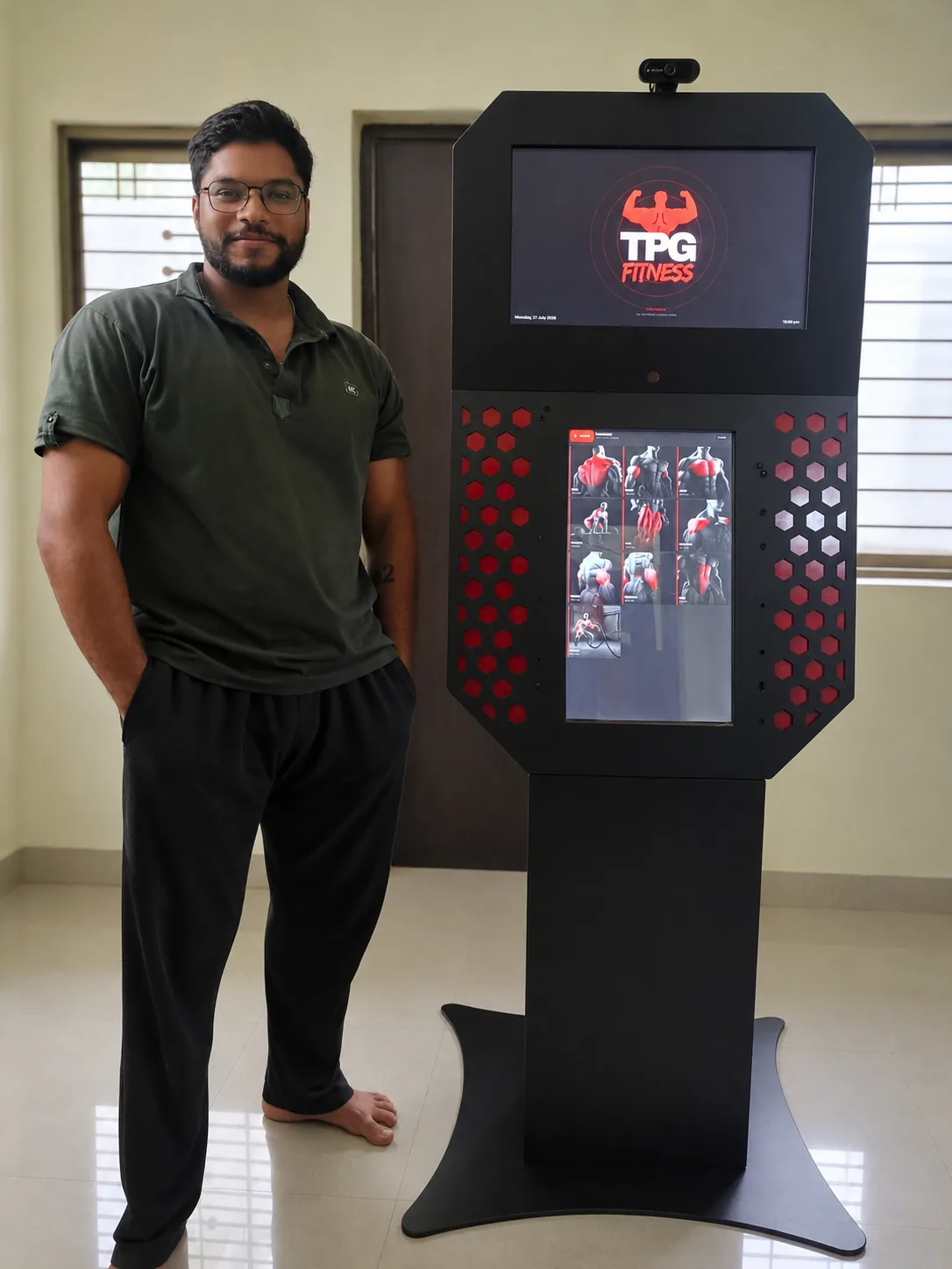 A TPG Fitness team member standing beside a finished kiosk unit