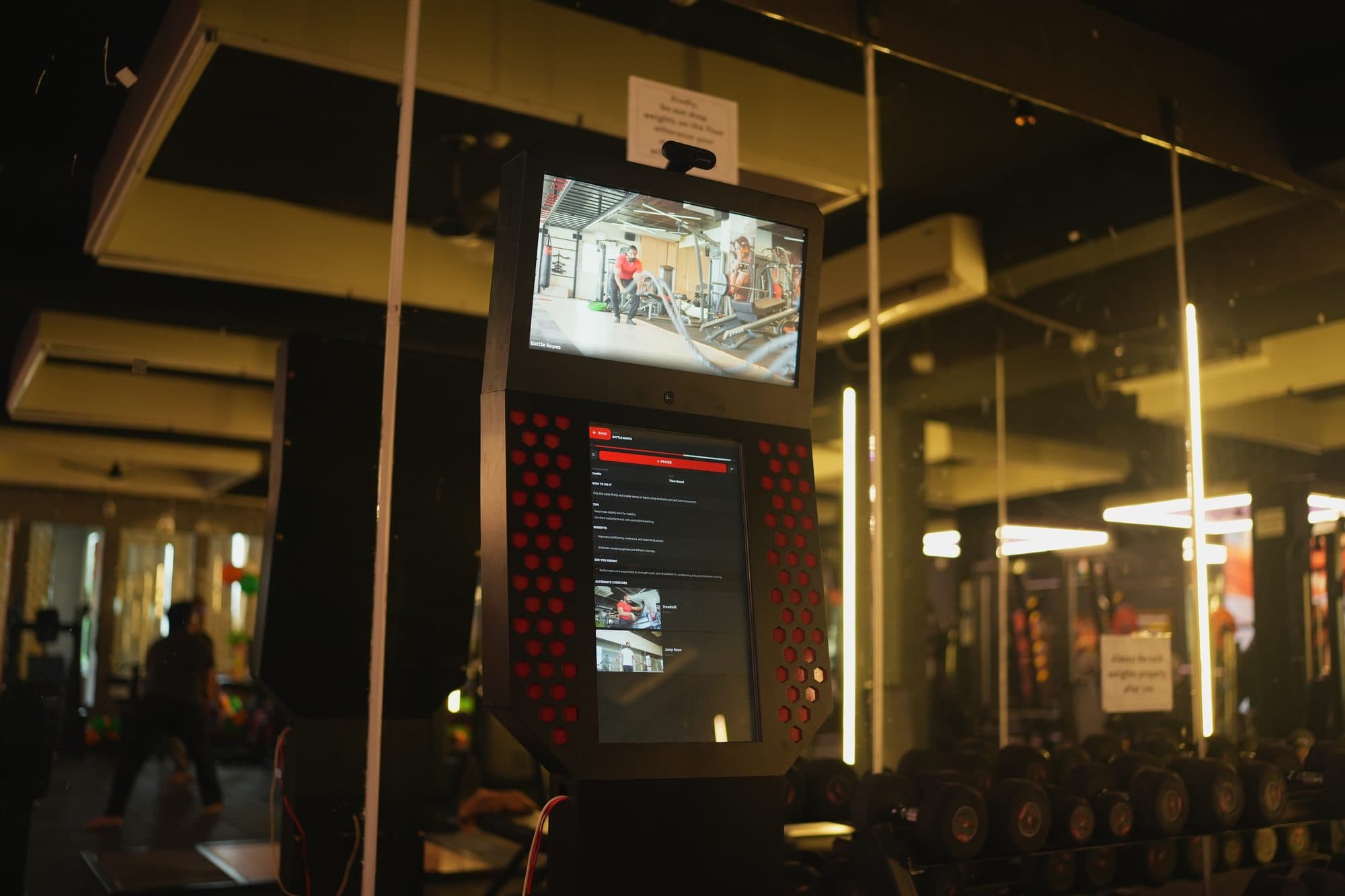 The kiosk reflected in the gym's mirrored walls