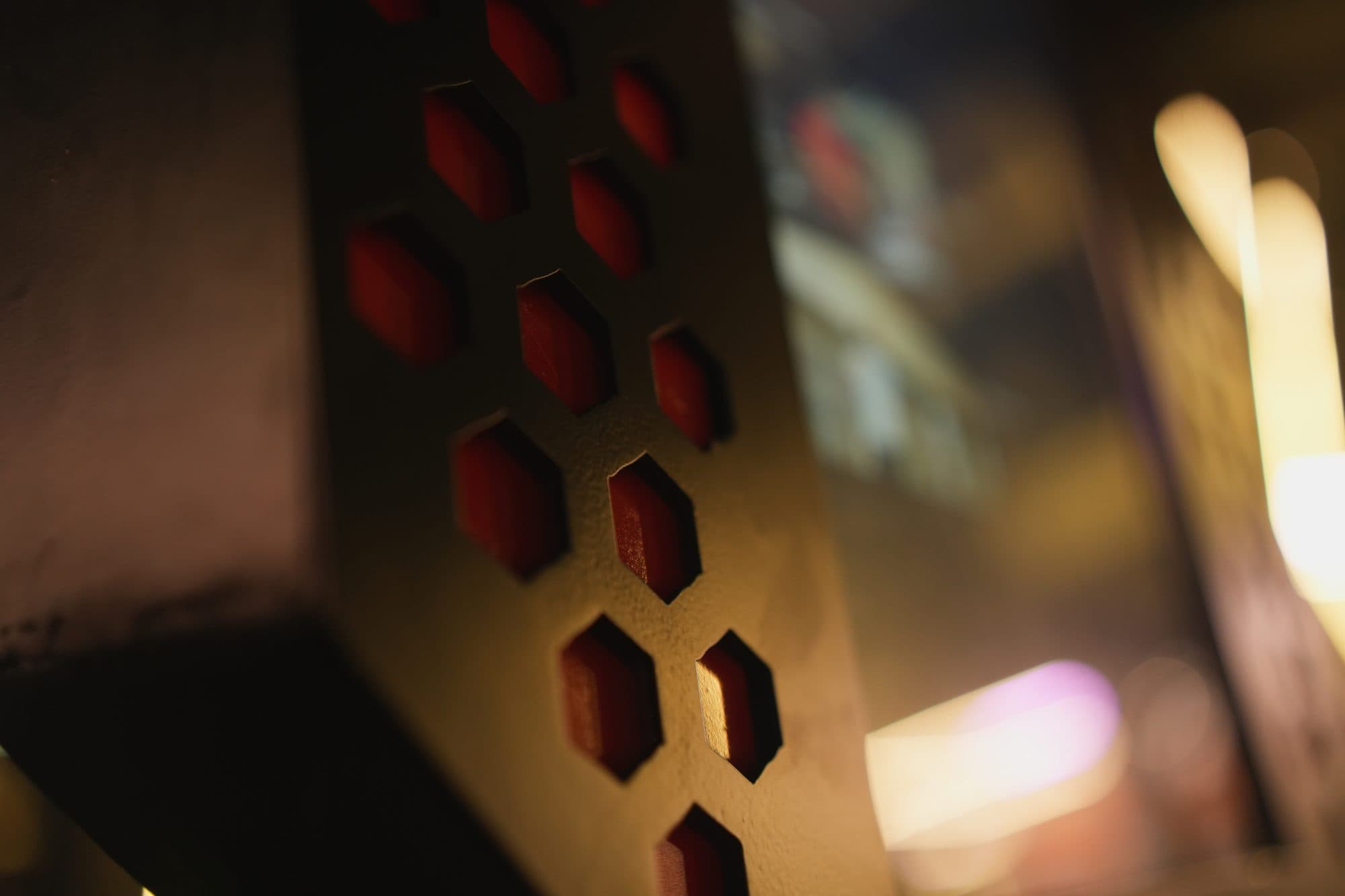 Close macro of the hexagonal vent panel with warm ambient light behind it
